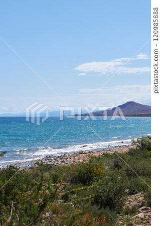 Stone coast of southern shore of Lake Issyk-Kul, summer vacation in Kyrgyzstan 120985888
