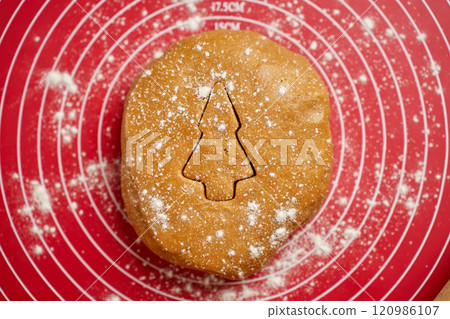 Christmas tree shape cut out in gingerbread dough 120986107