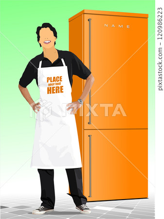Young man wearing an apron standing near a fridge is smiling at you Young man wearing an apron standing near a fridge is smiling at you 120986223