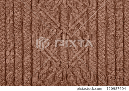 Demonstrating the colors of 2025 - Mocha Mousse. Knitted brown background. Large knitted fabric with a pattern. Close-up of a knitted blanket. Color concept. Demonstrating the colors of 2025 - Mocha Mousse. Knitted brown background. Large knitted fabric with a pattern. Close-up of a knitted blanket. Color concept. 120987604
