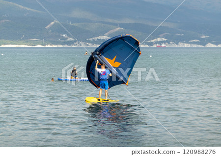 A kite surfer rides and jumps the waves the black sea 120988276