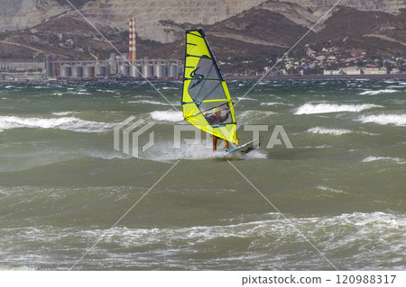 A kite surfer rides and jumps the waves the black sea 120988317
