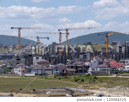 Novorossiysk many hoisting cranes and buildings under construction 120988329