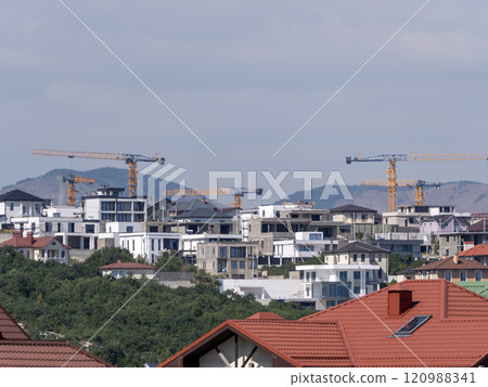 Novorossiysk many hoisting cranes and buildings under construction 120988341