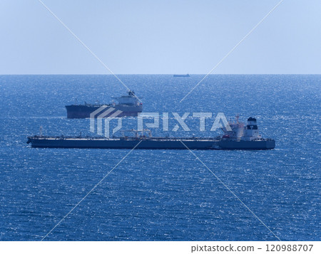 Sea freighter sailing in the middle of the ocean with big waves Sea freighter sailing in the middle of the ocean with big waves 120988707