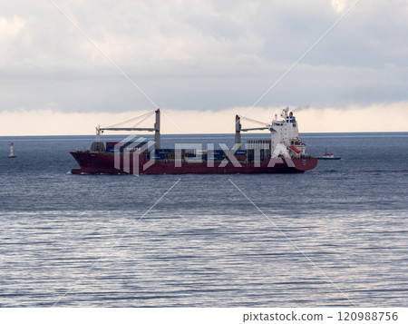 Sea freighter sailing in the middle of the ocean with big waves Sea freighter sailing in the middle of the ocean with big waves 120988756