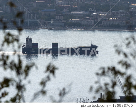 Sea freighter sailing in the middle of the ocean with big waves 120988760