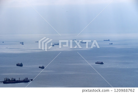 Sea freighter sailing in the middle of the ocean with big waves Sea freighter sailing in the middle of the ocean with big waves 120988762