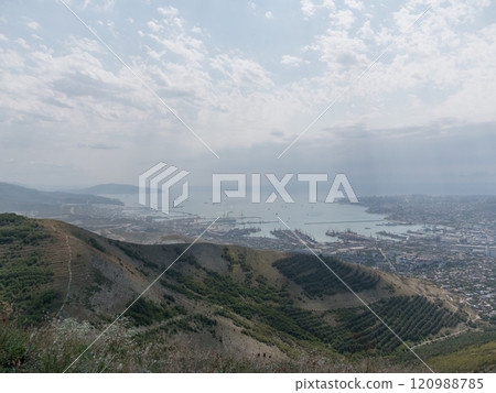Panoramic view of Novorossiysk City and Tsemess Bay at sunrise. Morning cityscape of large port at Black Sea coast in Russia 120988785