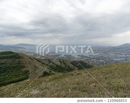 Panoramic view of Novorossiysk City and Tsemess Bay at sunrise. Morning cityscape of large port at Black Sea coast in Russia Panoramic view of Novorossiysk City and Tsemess Bay at sunrise. Morning cityscape of large port at Black Sea coast in Russia 120988853