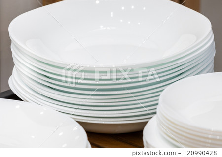 Many white different plates stacked together 120990428