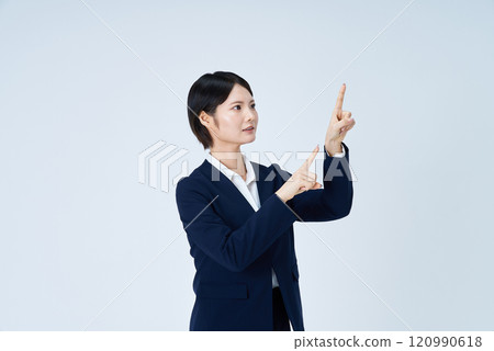 Young business woman pointing up Young business woman pointing up 120990618