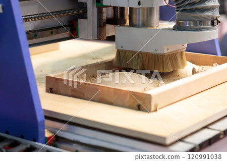 close up of CNC router machine carving wood close up of CNC router machine carving wood 120991038