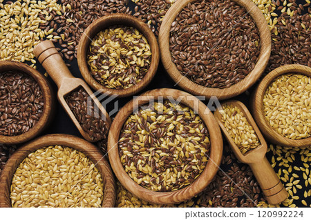 Colorful mix of various flax seeds: golden and brown; vegan food background Colorful mix of various flax seeds: golden and brown; vegan food background 120992224