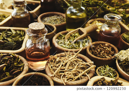 Essential oil bottles and medicinal herbs background, alternative medicine background, selective focus, shallow DOF 120992230