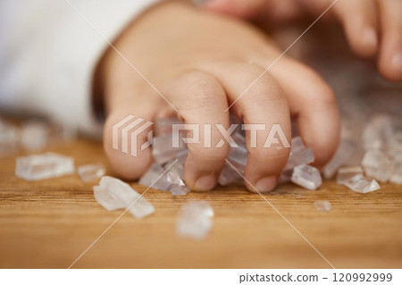 close-up of little child girl hand holds small cubes of soap for hand-made soap, art workshops for children. 120992999
