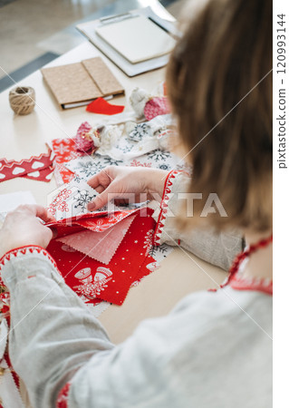 Holiday-themed fabric with snowflake patterns. Promoting sustainable gift wrapping, eco-friendly celebrations, and reusable materials for zero-waste holidays. Holiday-themed fabric with snowflake patterns. Promoting sustainable gift wrapping, eco-friendly celebrations, and reusable materials for zero-waste holidays. 120993144