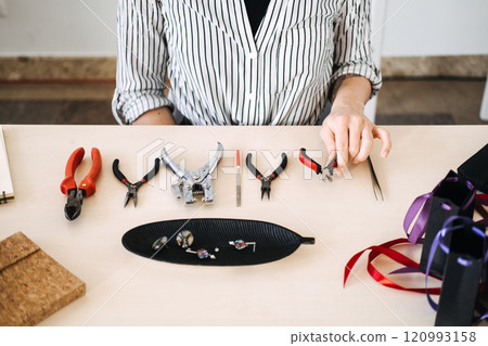 Artisan crafting workspace with jewelry-making tools. Highlighting professional craftsmanship and the essentials of handmade creativity. 120993158