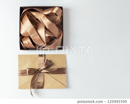 a box on a white background with a ribbon of mocha mousse color and gift certificate 120993500
