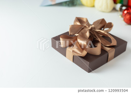 brown gift box with a mocha mousse color satin ribbon bow 120993504