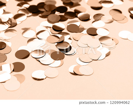 A close-up of scattered round confetti in beige, white, and brown tones on a neutral background A close-up of scattered round confetti in beige, white, and brown tones on a neutral background 120994062
