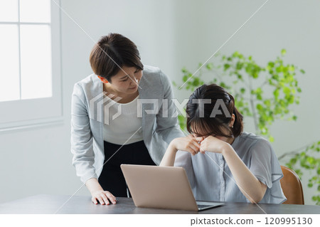 A crying businesswoman and a troubled senior 120995130