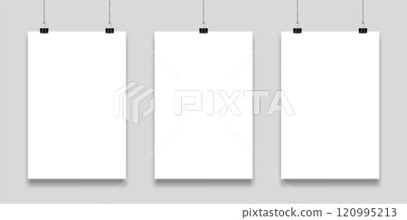 Three blank white papers are hanging on a gray wall, held by black binder clips, providing a clean and professional backdrop for displaying artwork or announcements Three blank white papers are hanging on a gray wall, held by black binder clips, providing a clean and professional backdrop for displaying artwork or announcements 120995213