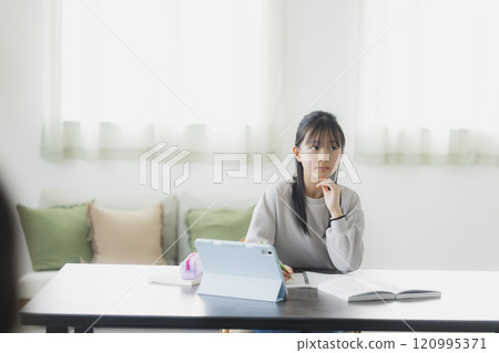 Elementary school students learning on tablets 120995371