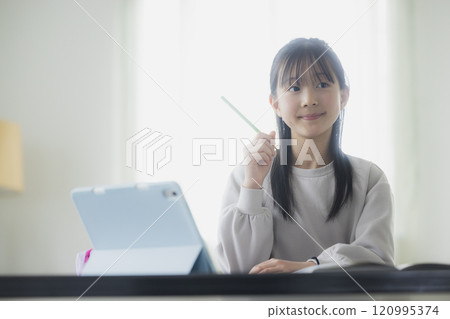 Elementary school students learning on tablets 120995374