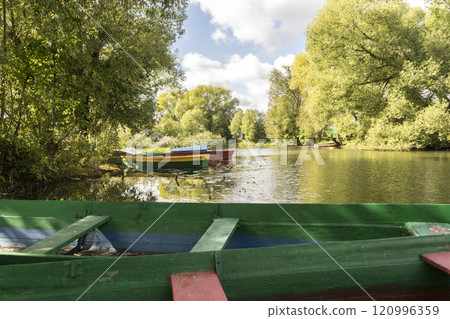 Rowing boat floating over the Lake. Fishing lake in early summer. 120996359