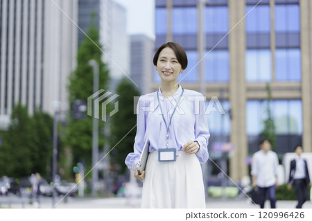 Portrait of a businesswoman holding a laptop in an office district Portrait of a businesswoman holding a laptop in an office district 120996426