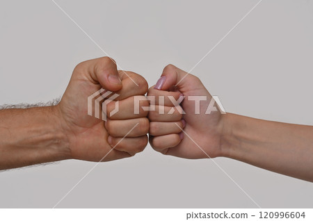 fist to fist, male and female. on a white background. 120996604