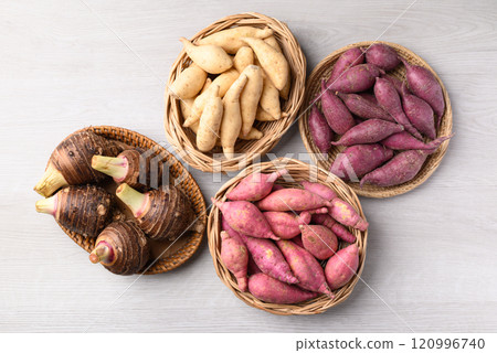 Organic raw sweet potatoes and taro on white background, Table top view Organic raw sweet potatoes and taro on white background, Table top view 120996740