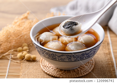 Tangyuan (Chinese sweet dumpling), Glutinous rice flour filling with black sesame in ginger syrup Tangyuan (Chinese sweet dumpling), Glutinous rice flour filling with black sesame in ginger syrup 120996741