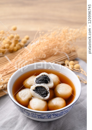 Tangyuan (Chinese sweet dumpling), Glutinous rice flour filling with black sesame in ginger syrup Tangyuan (Chinese sweet dumpling), Glutinous rice flour filling with black sesame in ginger syrup 120996745