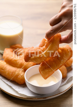 Asian deep fried dough eaten with soy milk and condensed milk, Thai style breakfast Asian deep fried dough eaten with soy milk and condensed milk, Thai style breakfast 120996761