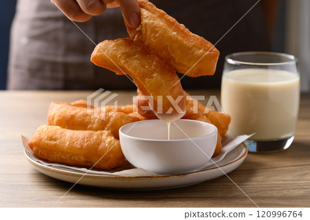 Asian deep fried dough eaten with soy milk and condensed milk, Thai style breakfast Asian deep fried dough eaten with soy milk and condensed milk, Thai style breakfast 120996764
