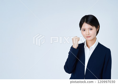A young woman in a suit posing for support A young woman in a suit posing for support 120997030