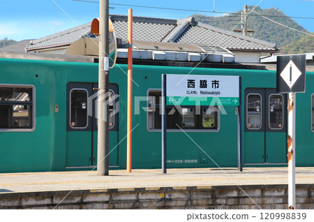 JR Nishiwaki Station platform and trains stopping there JR Nishiwaki Station platform and trains stopping there 120998839