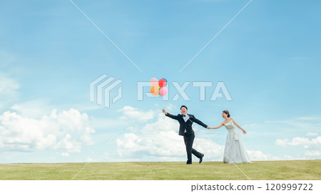 Bride and groom running with balloons under the blue sky (wedding, wedding ceremony, bridal, photo wedding) Bride and groom running with balloons under the blue sky (wedding, wedding ceremony, bridal, photo wedding) 120999722