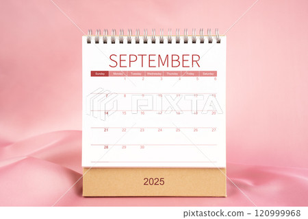 Front view of blank September 2025 desk calendar on pink textile. Front view of blank September 2025 desk calendar on pink textile. 120999968