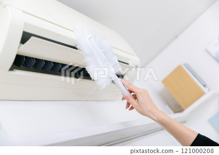 Hands cleaning the air conditioner Hands cleaning the air conditioner 121000208
