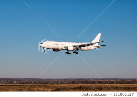 Landing white wide-body passenger aircraft 121001127