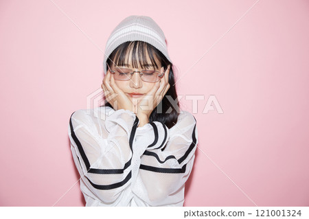 粉紅色背景下拍攝的一位穿著運動服的年輕女子的可愛肖像 121001324