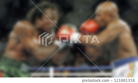 Blurred backdrop of a roaring crowd, a determined boxer 121001358