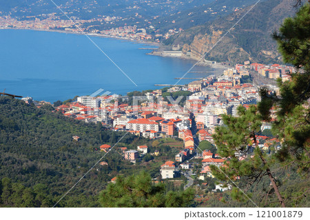 View of sea and city of Liguria from mountain. Nature and traditional buildings. Sunny day. Cove and landscape of Mediterranean Sea. Tourism and vacation. View of sea and city of Liguria from mountain. Nature and traditional buildings. Sunny day. Cove and landscape of Mediterranean Sea. Tourism and vacation. 121001879