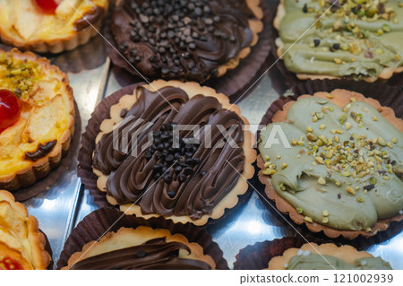 Chocolate and pistachio cream decorated tart 121002939