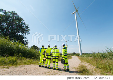Team of electrical engineer is perform the inspection and maintenance of electric generating windmill turbine. Team of electrical engineer is perform the inspection and maintenance of electric generating windmill turbine. 121003877