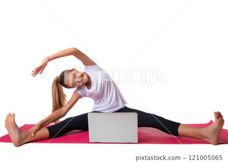 Sporty young woman sitting in pink yoga mat in white T-shirt, doing exercises, watching online yoga class on laptop computer, isolated Sporty young woman sitting in pink yoga mat in white T-shirt, doing exercises, watching online yoga class on laptop computer, isolated 121005065