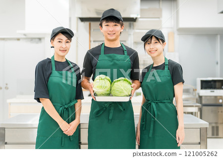 Male and female kitchen staff and cooking staff in the kitchen and back room 121005262